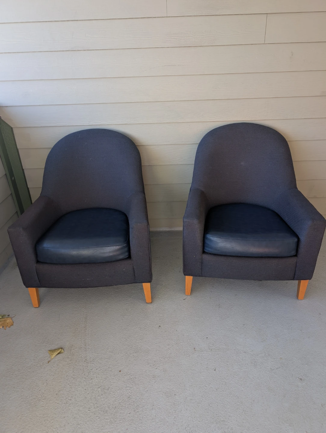 Two navy blue fabric armchairs