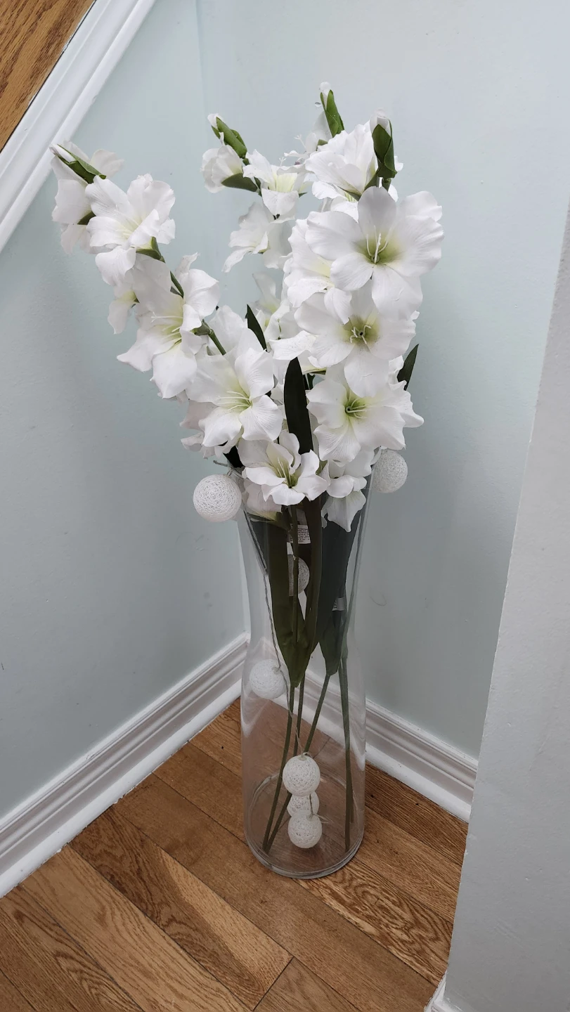 Clear glass vase with faux white gladiolus flowers