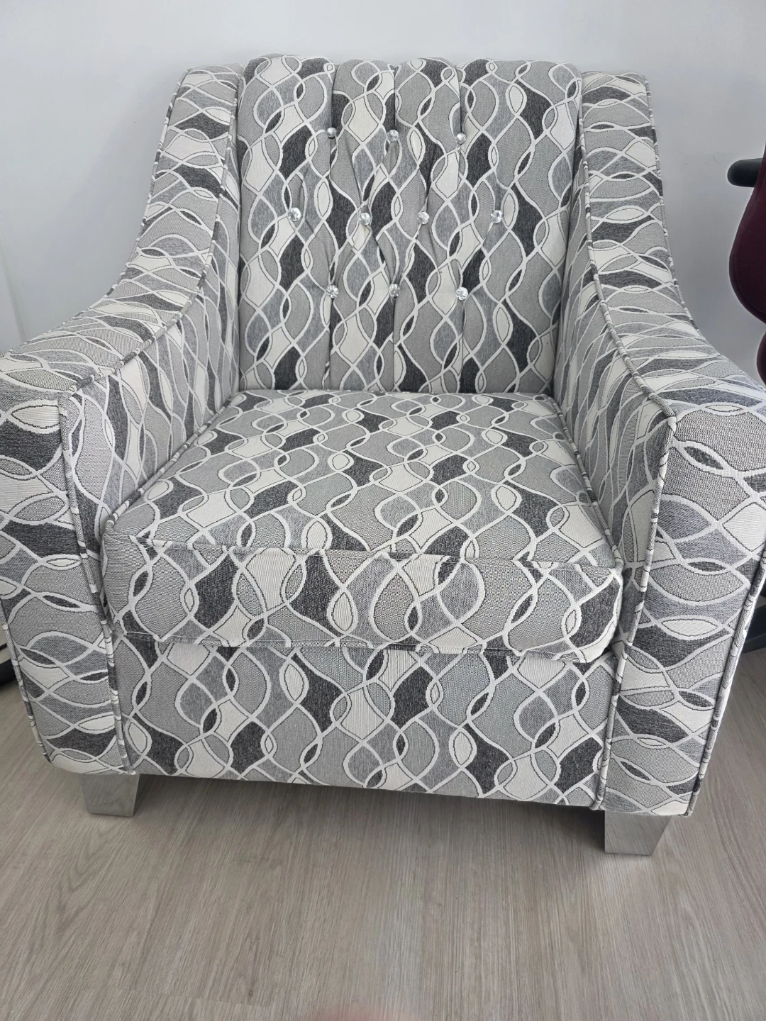 Grey patterned accent chair with crystal buttons