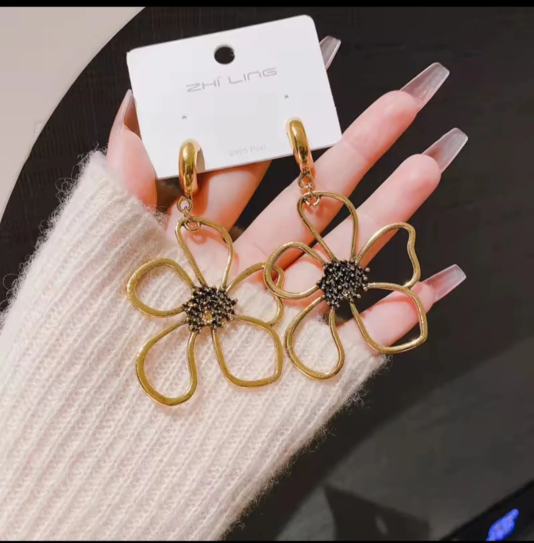 Big golden-tone flower earrings
