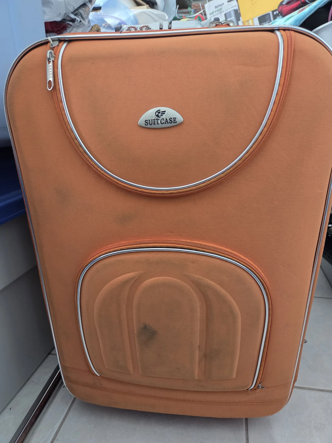 Orange rolling suitcase with combination lock