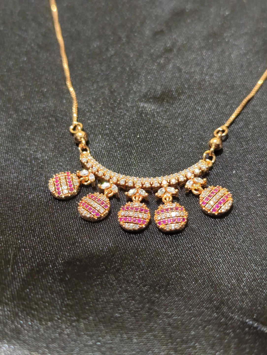 Gold-tone necklace with pink and clear stones