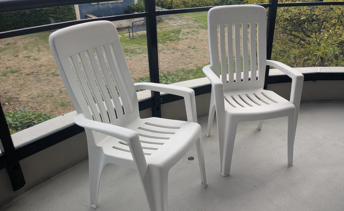 Two White Plastic Patio Chairs