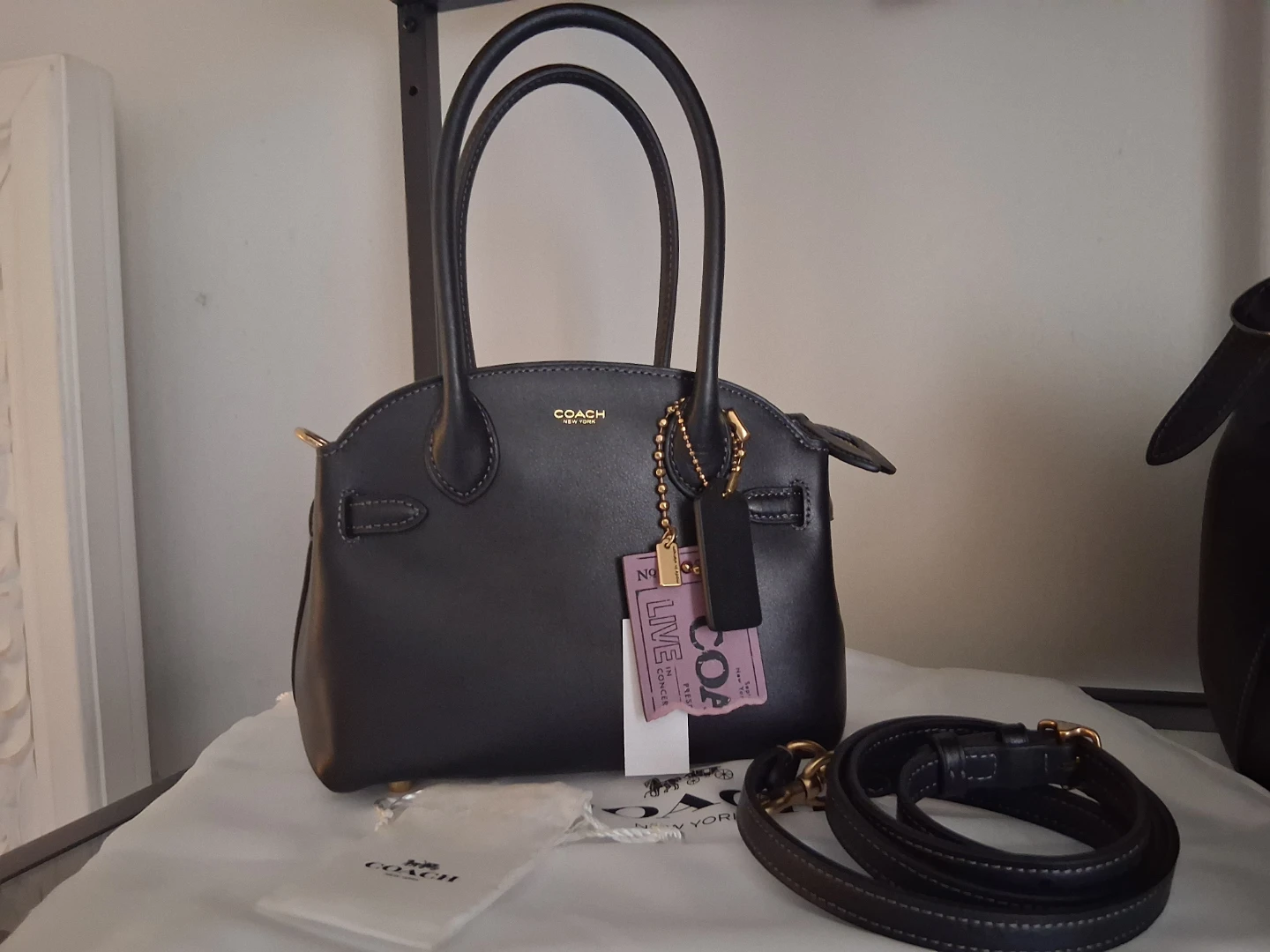Coach empire 21 with ticket charm