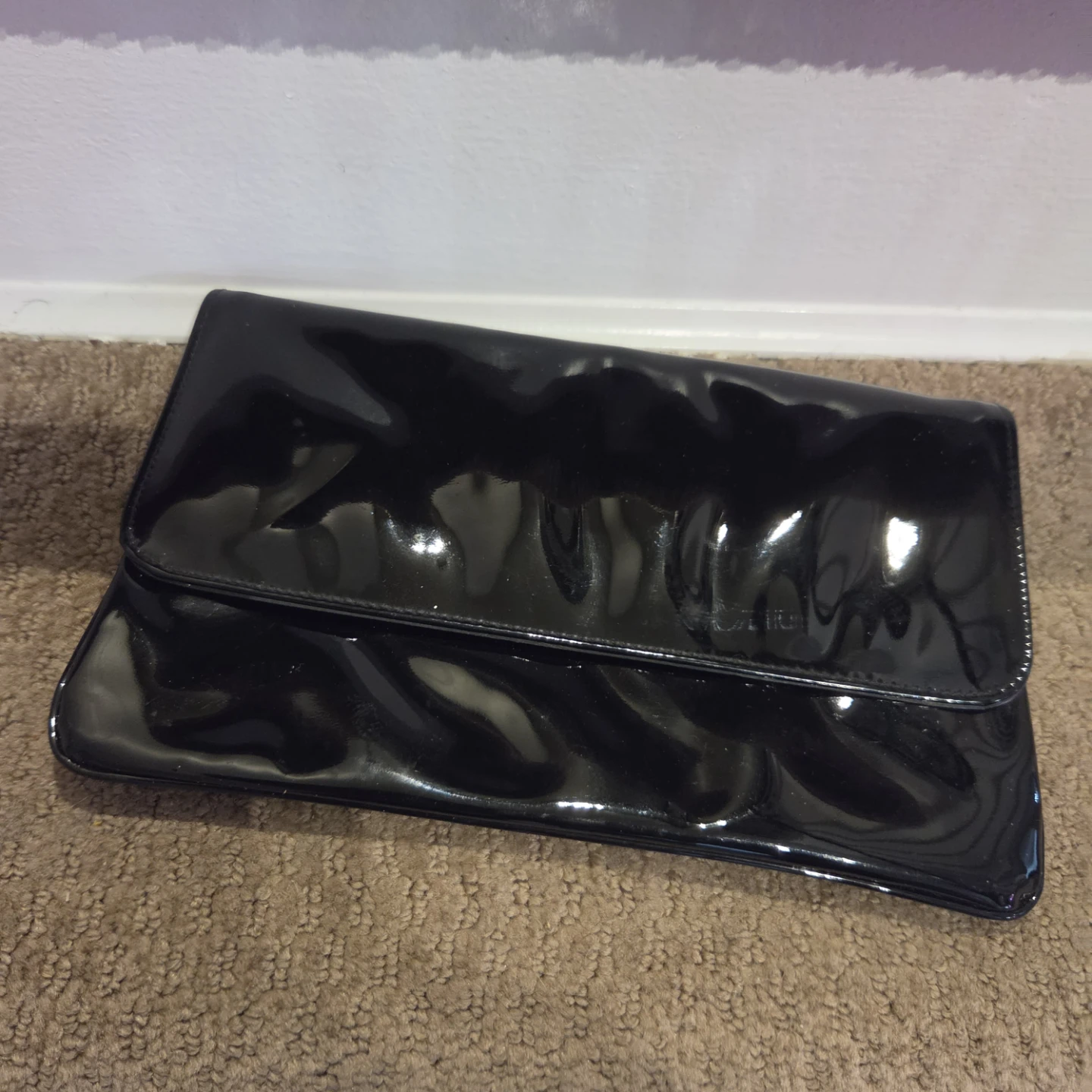 Black patent leather clutch bag