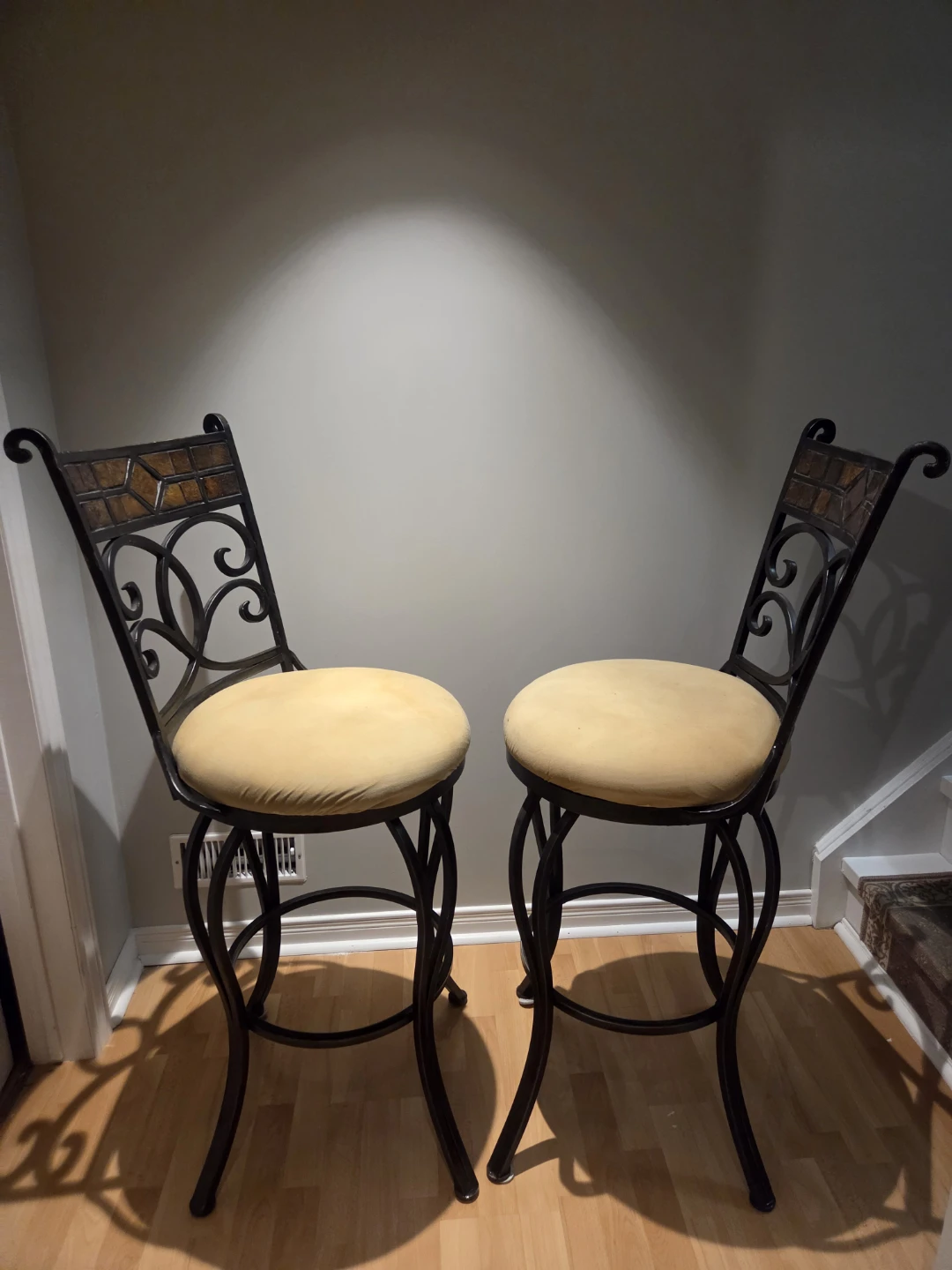 Two decorative metal bar stools