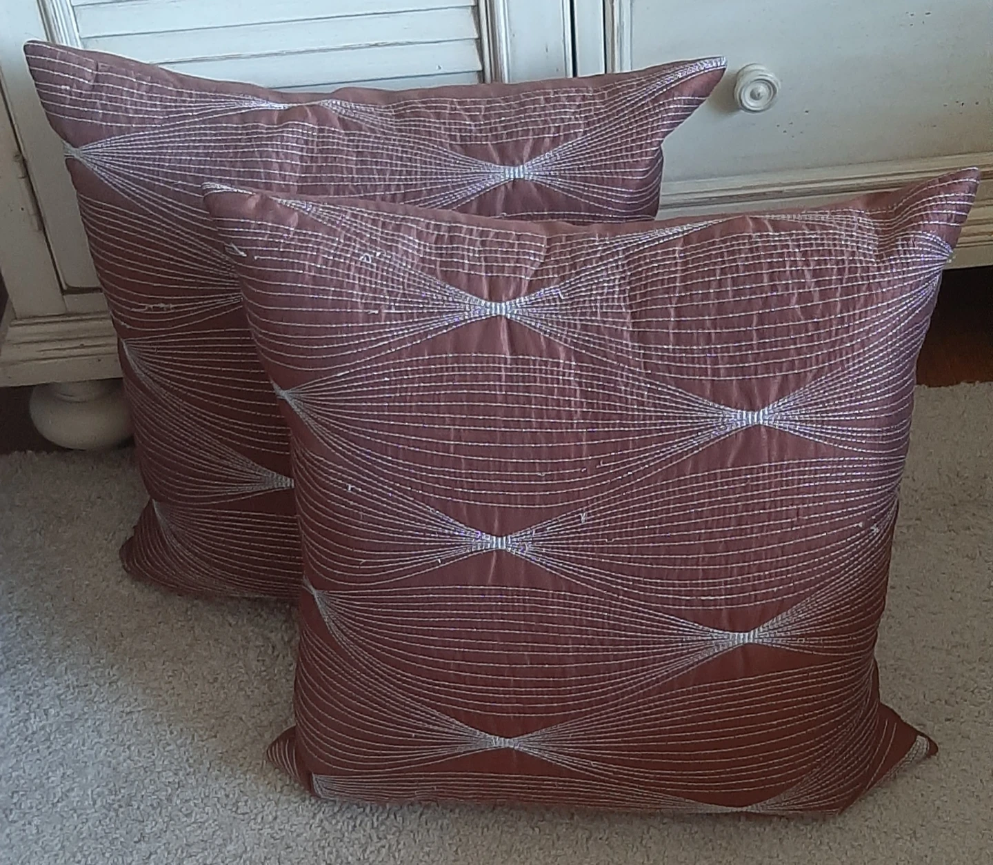 Two rust decorative throw pillows