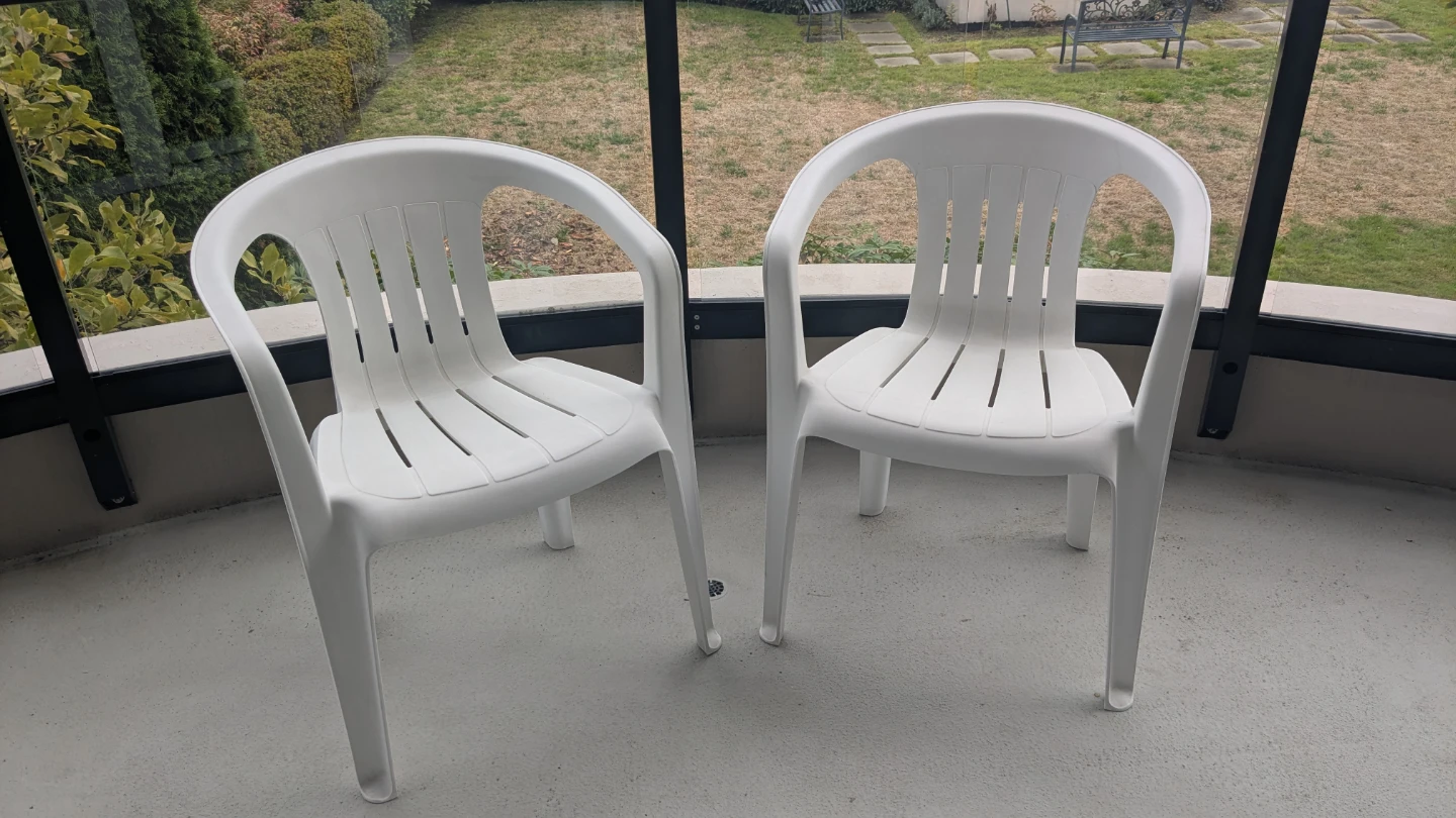 Two White Plastic Patio Chairs