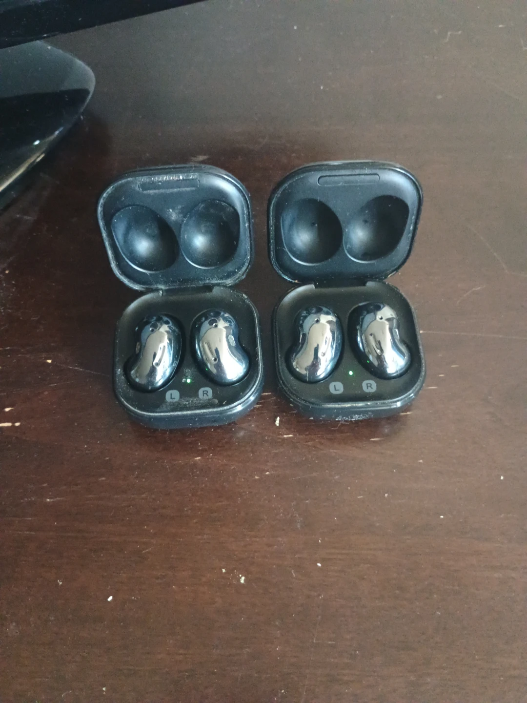 Two Samsung Galaxy Buds Live Charging Cases and Earbuds