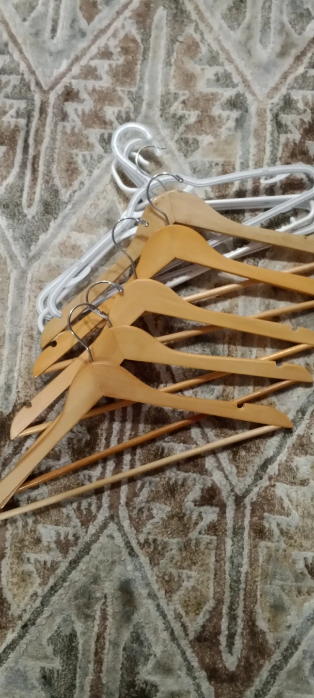 Assorted wooden and plastic clothes hangers