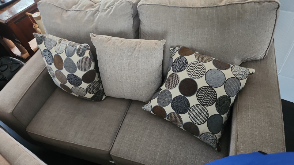 cream sofa and love seat with accent cushions