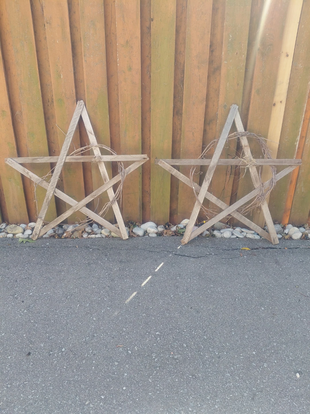 Two rustic wooden star decorations