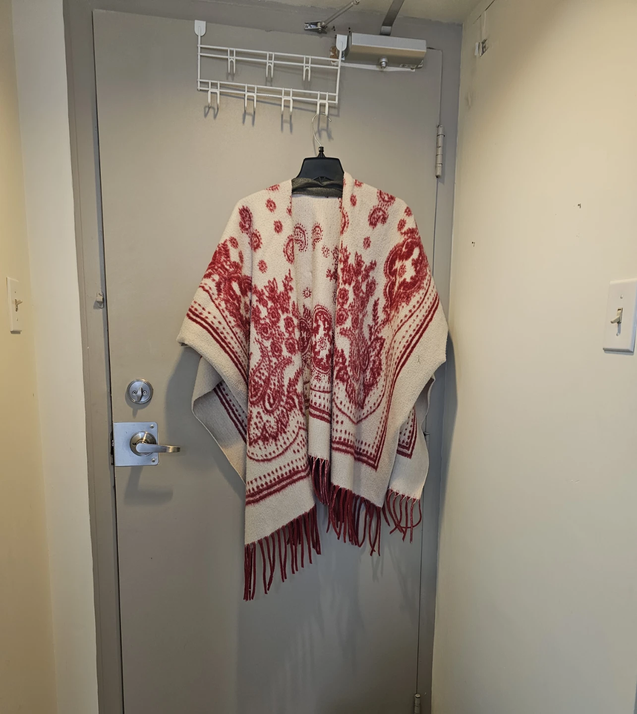Red and cream patterned poncho