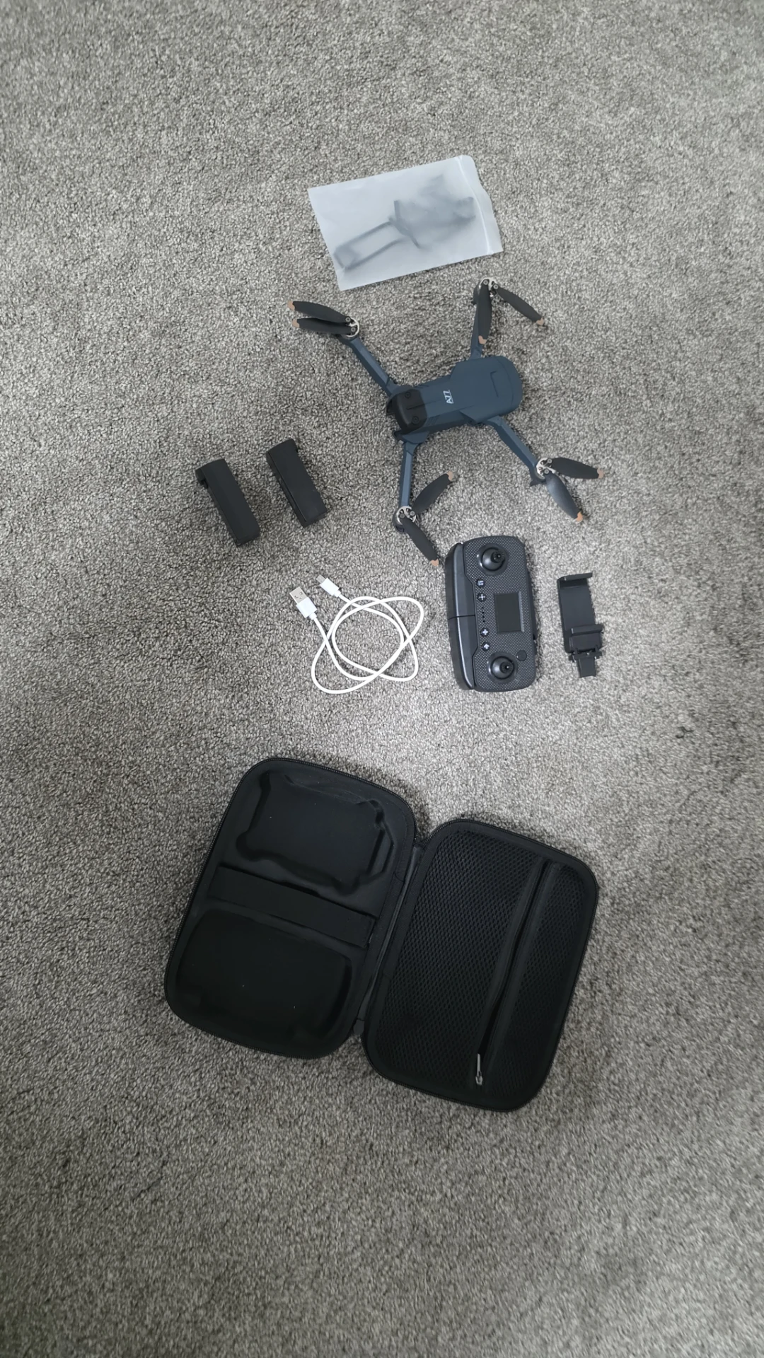 Drone with controller, batteries, and carrying case