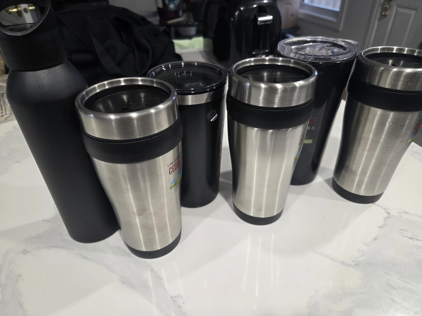 Set of 7 assorted travel mugs and water bottles