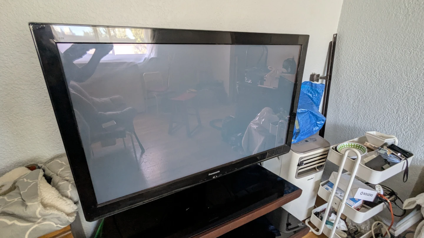 Panasonic television with 3-tier glass and wood stand