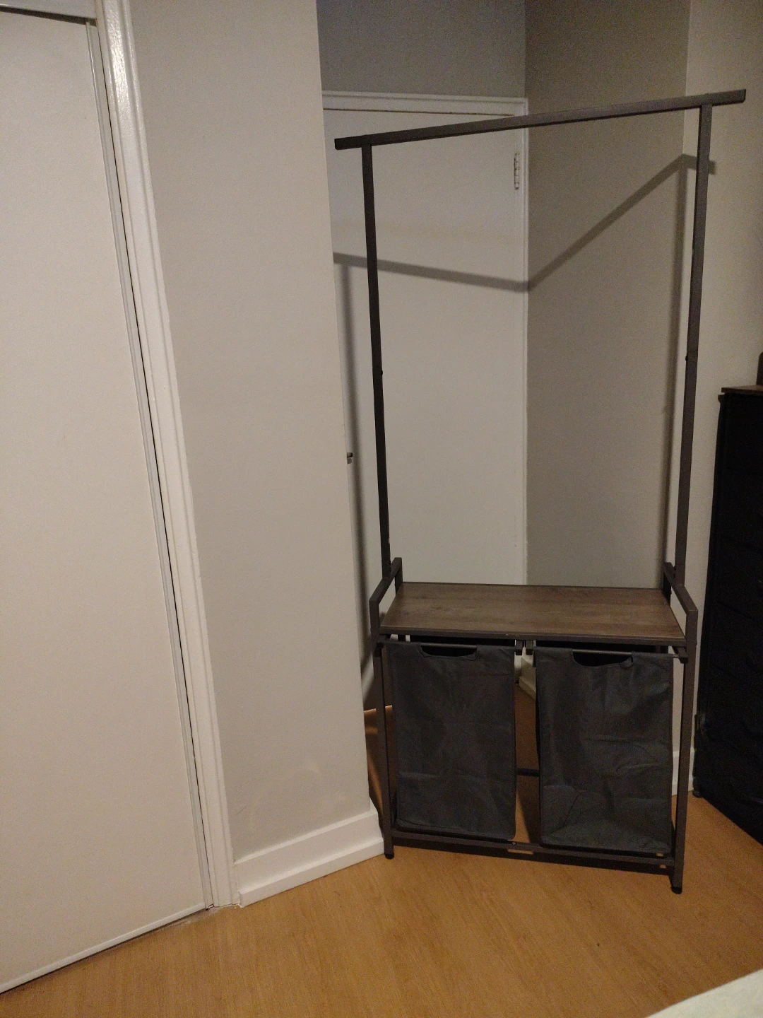Clothing rack with dual laundry hampers