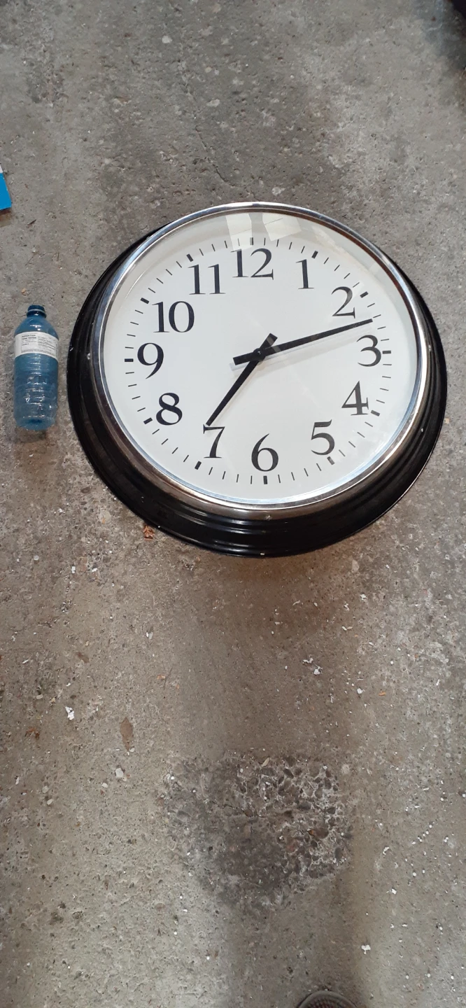 Large round wall clock with black frame