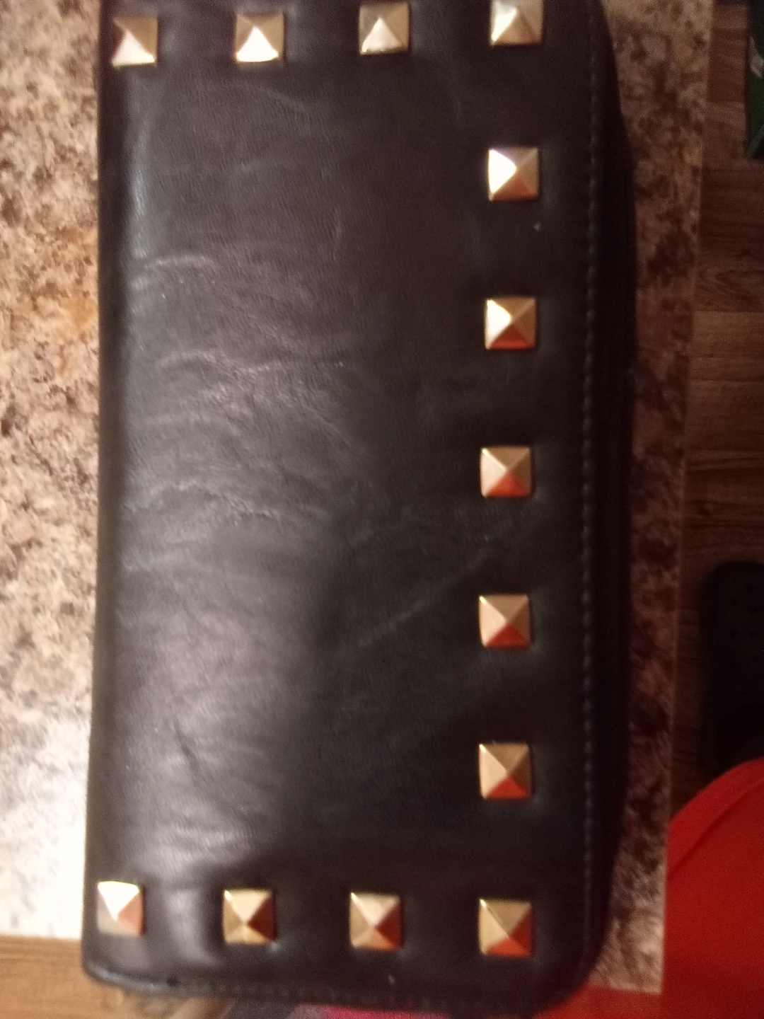 Black studded clutch and coral crossbody bag
