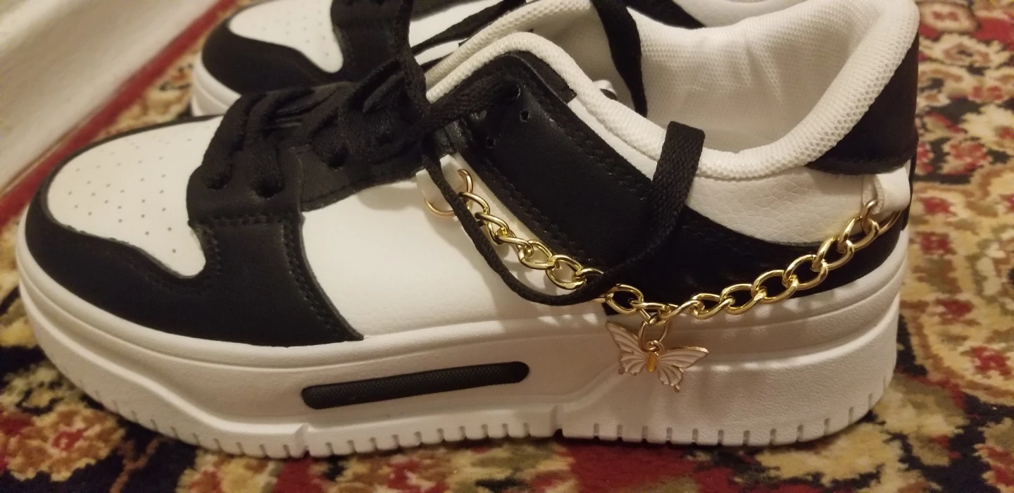 Black and white sneakers with butterfly chains