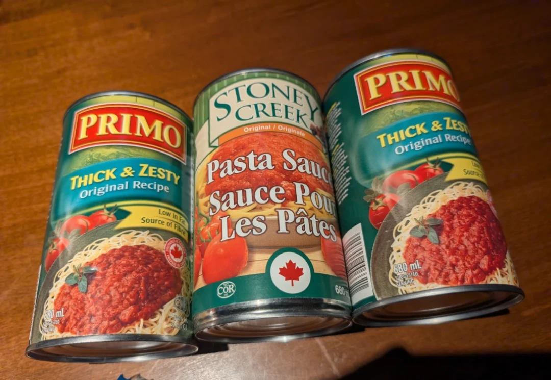 Three cans of pasta sauce