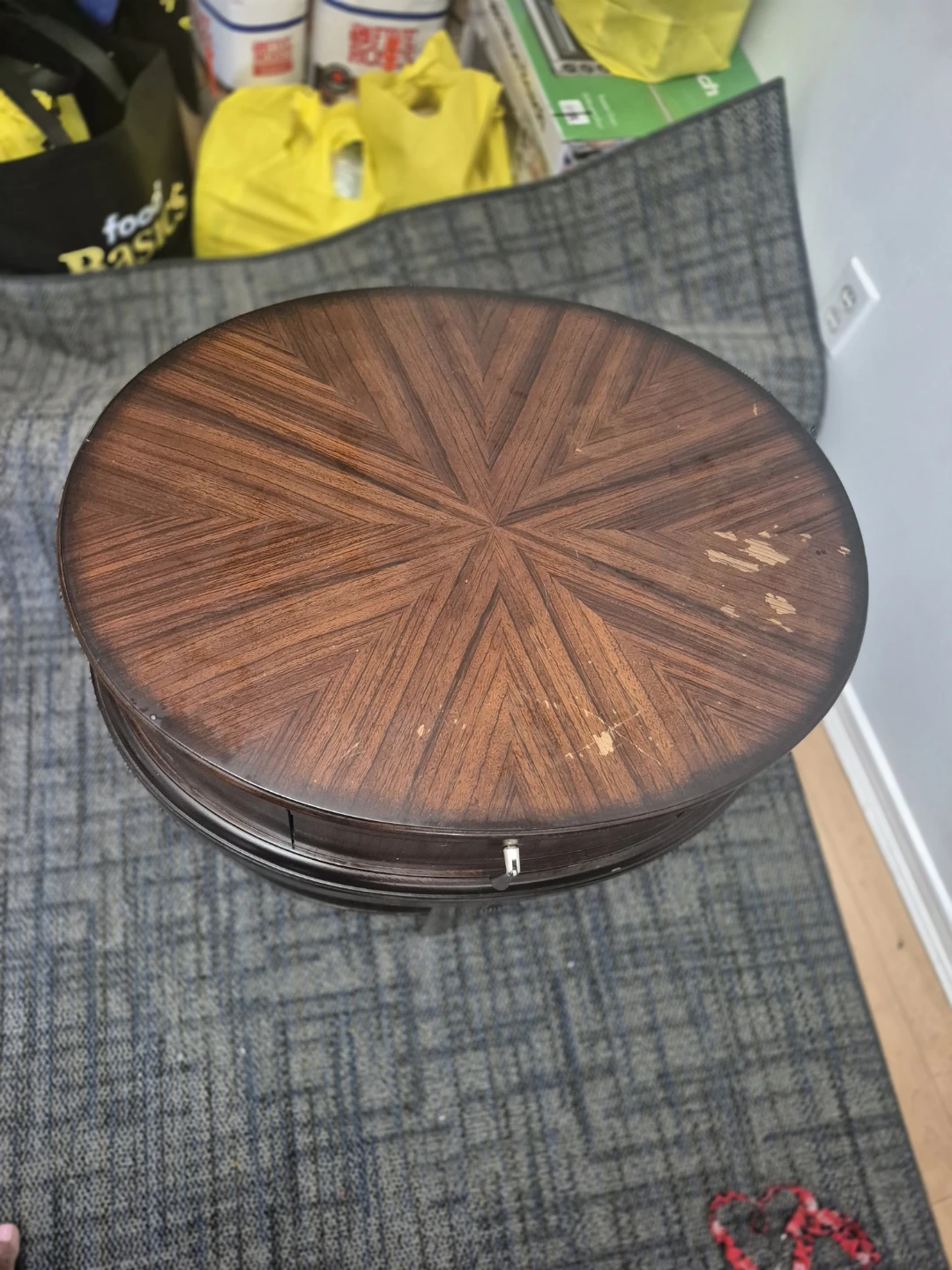 Round wooden side table with drawer