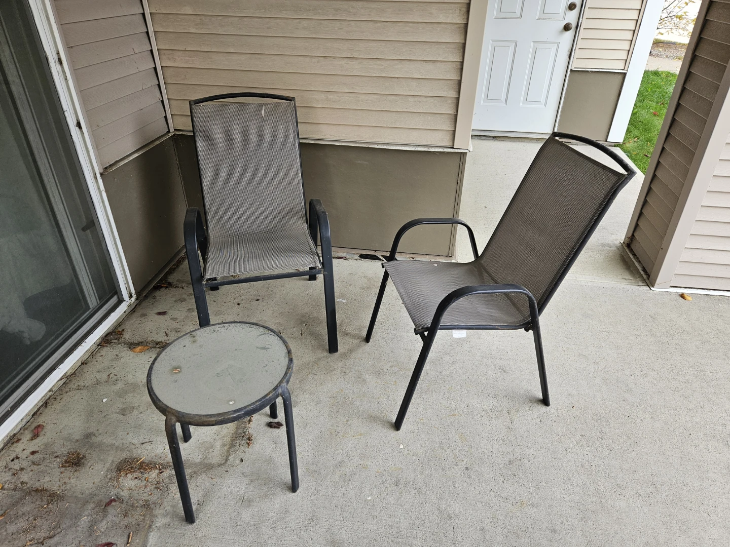 Outdoor patio set with two chairs and a side table