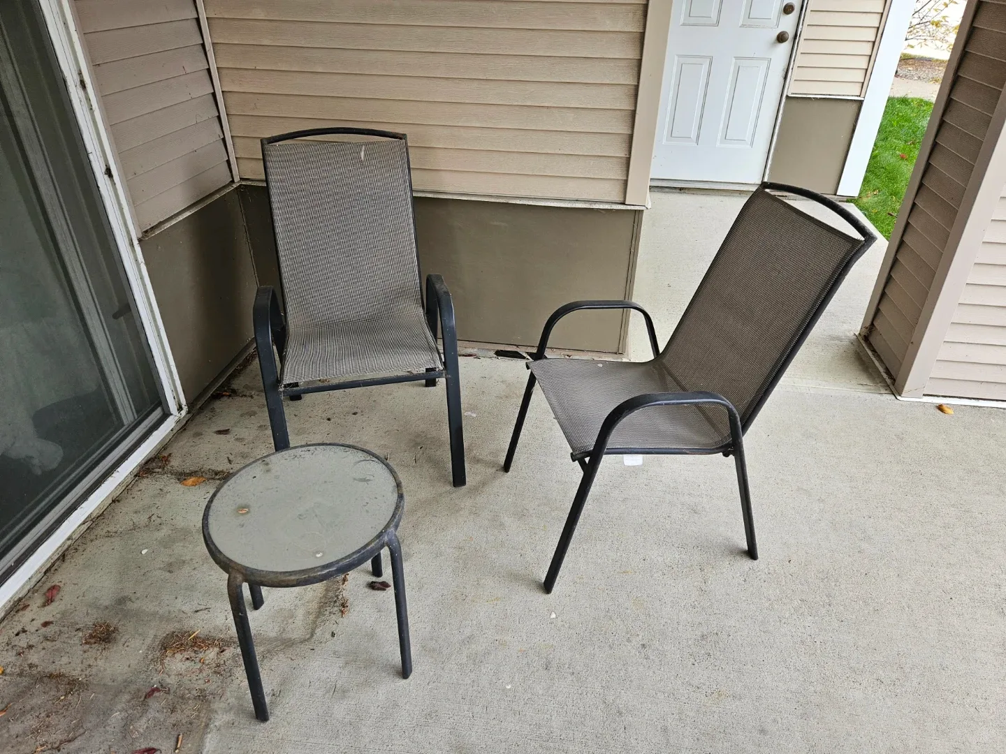 Outdoor patio set with two chairs and a side table