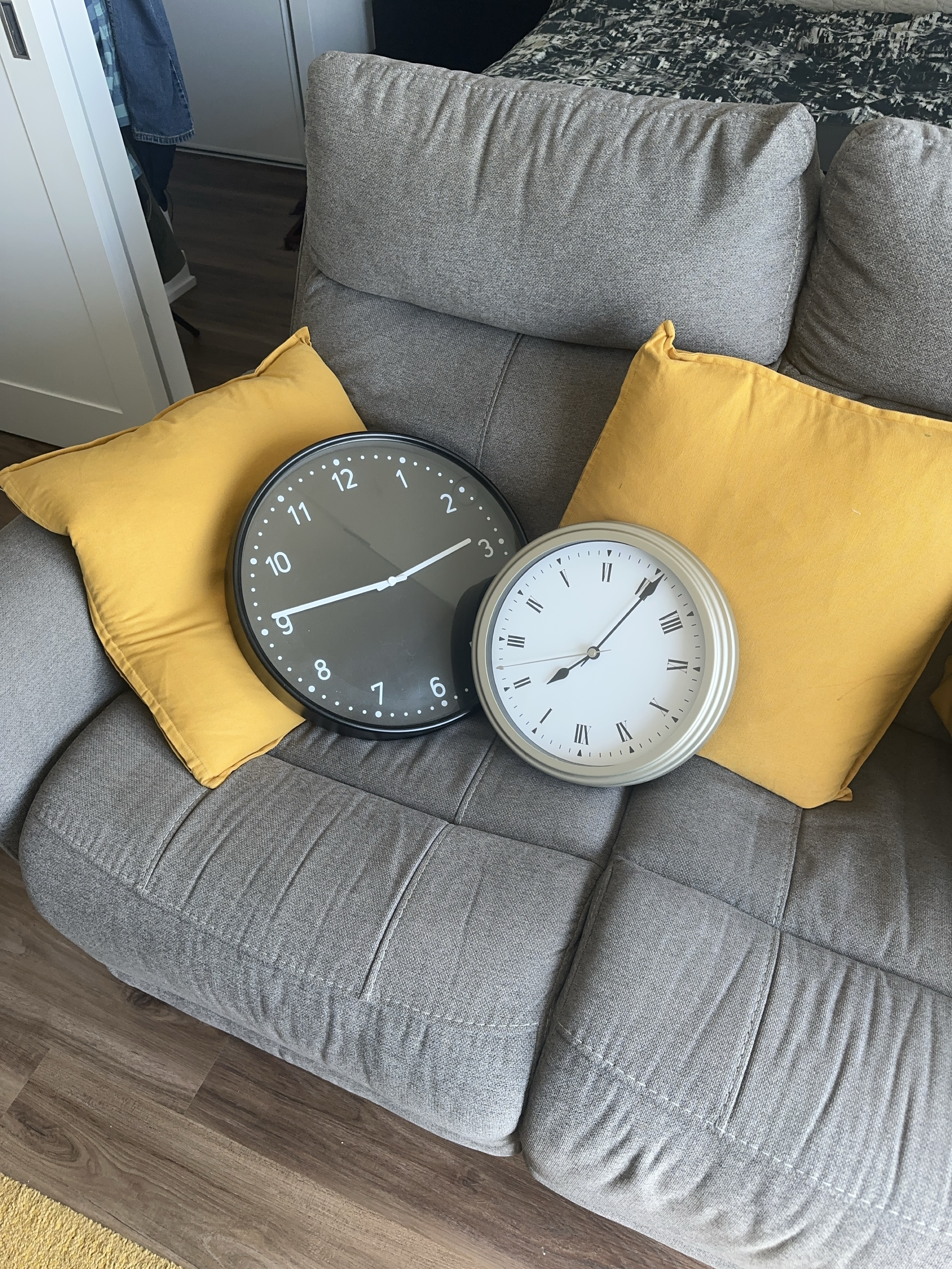 Two wall clocks, modern and roman numeral designs thumbnail
