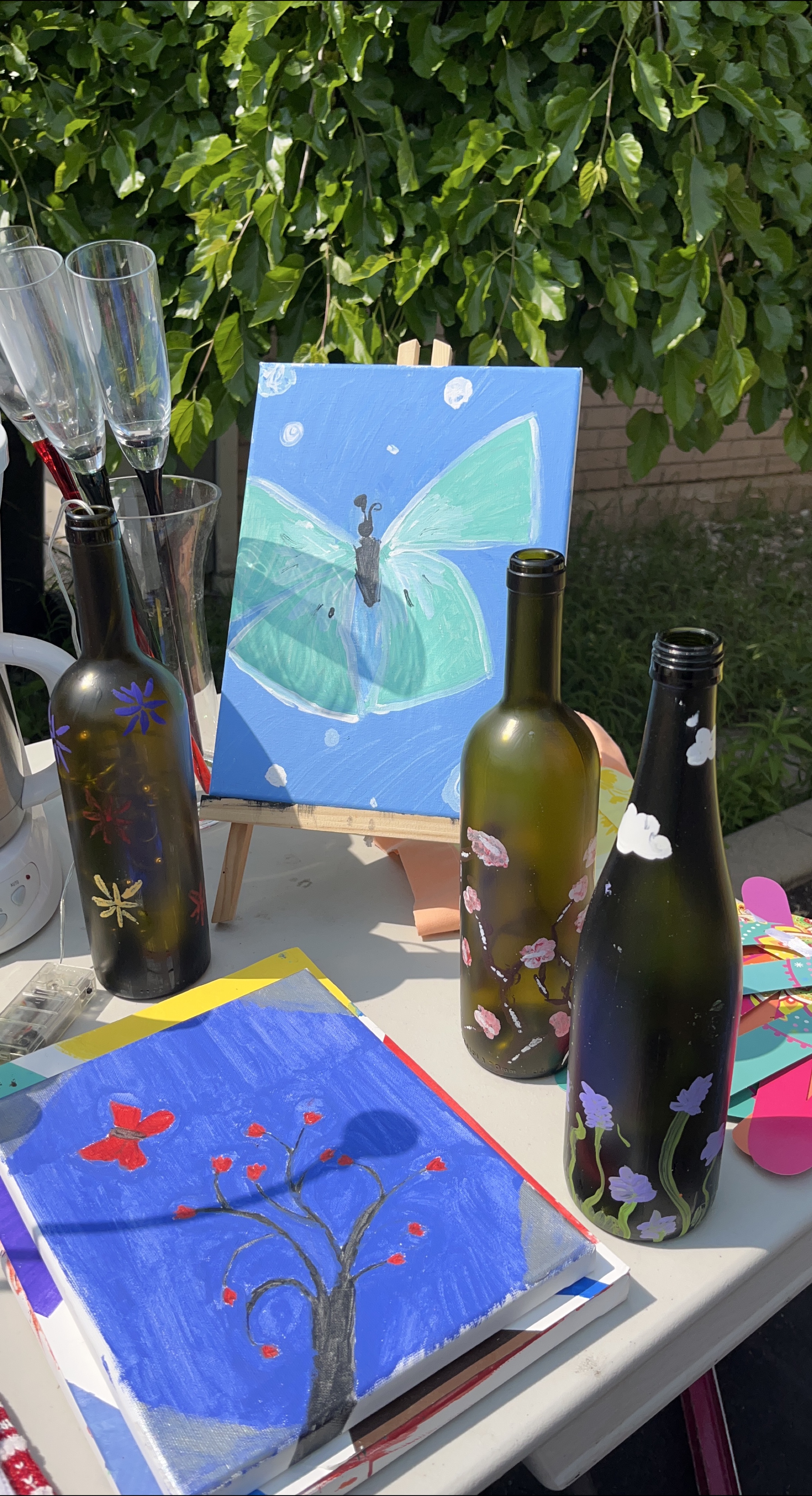 Hand-painted wine bottles and canvas art