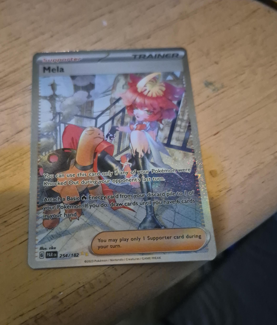 Mela Supporter Trainer Card thumbnail