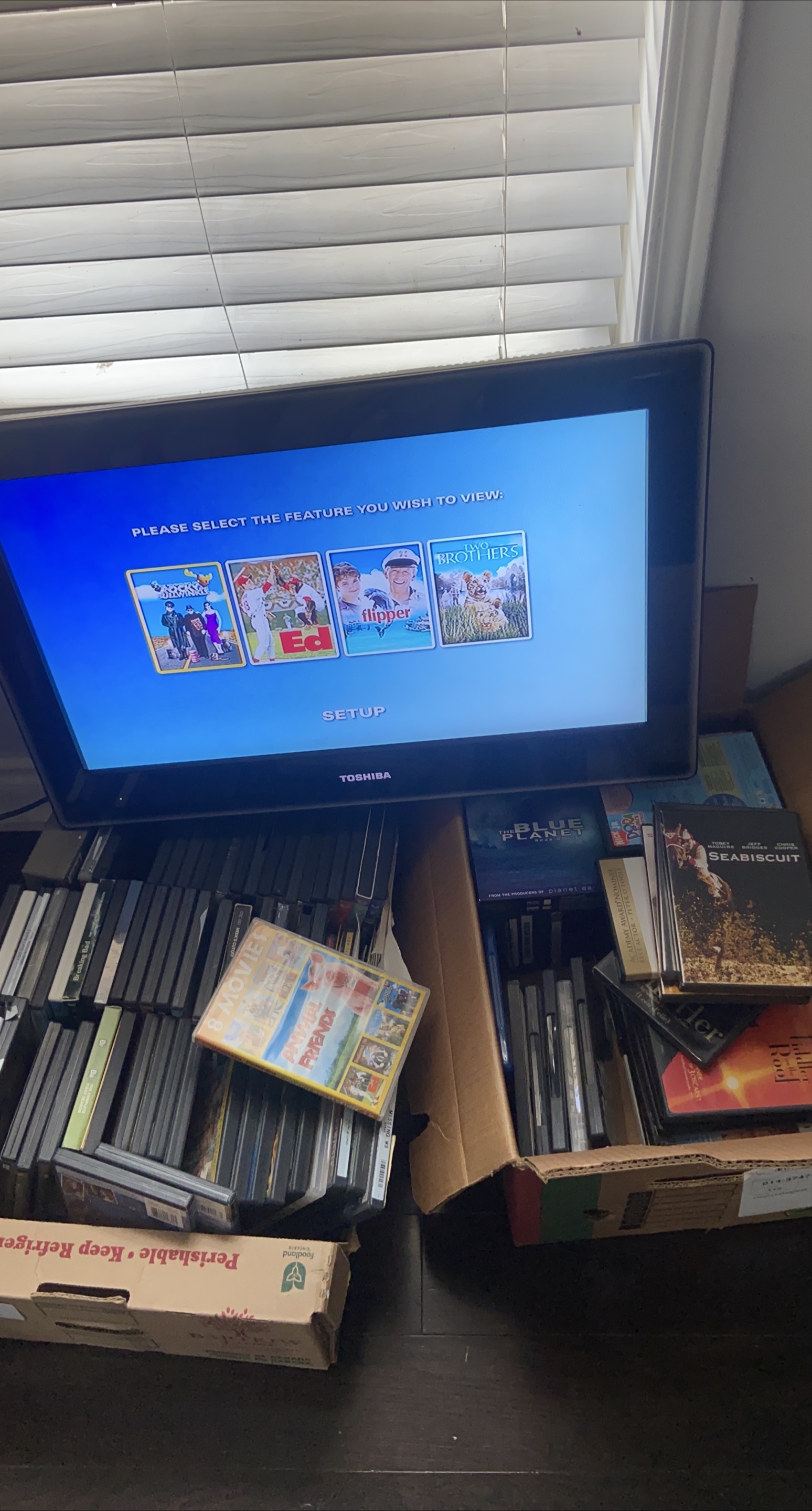 Tv with dvd player inserted and DVD  collection thumbnail