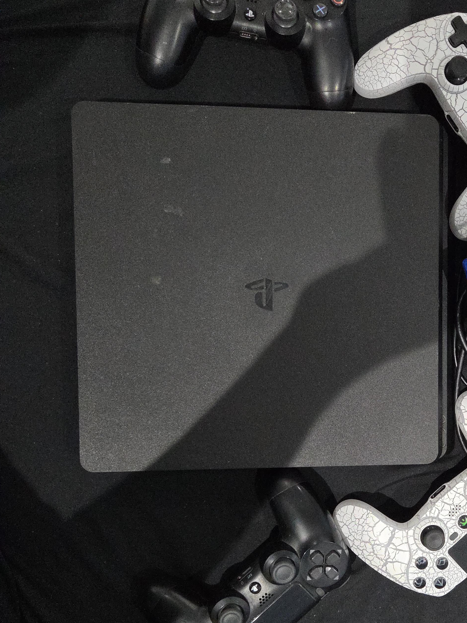PlayStation 4 Slim with Games and Controllers thumbnail