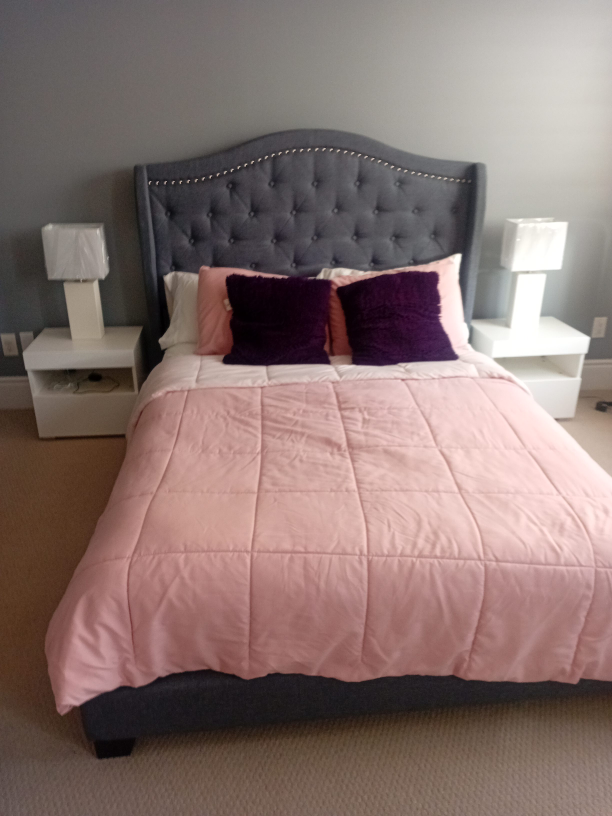 Upholstered Bed Frame with Pink Quilt thumbnail