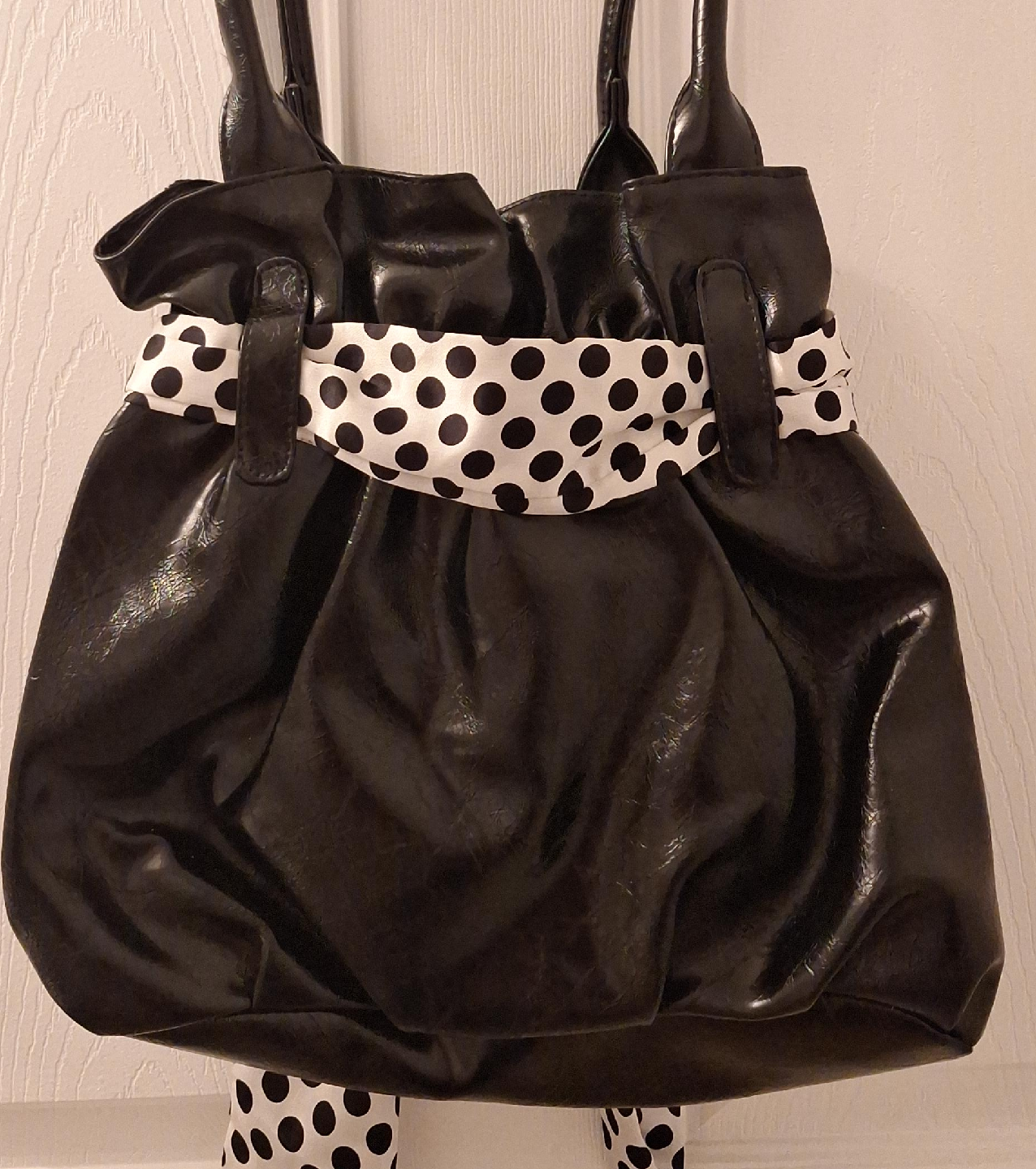 Black handbag with polka dot accent thumbnail