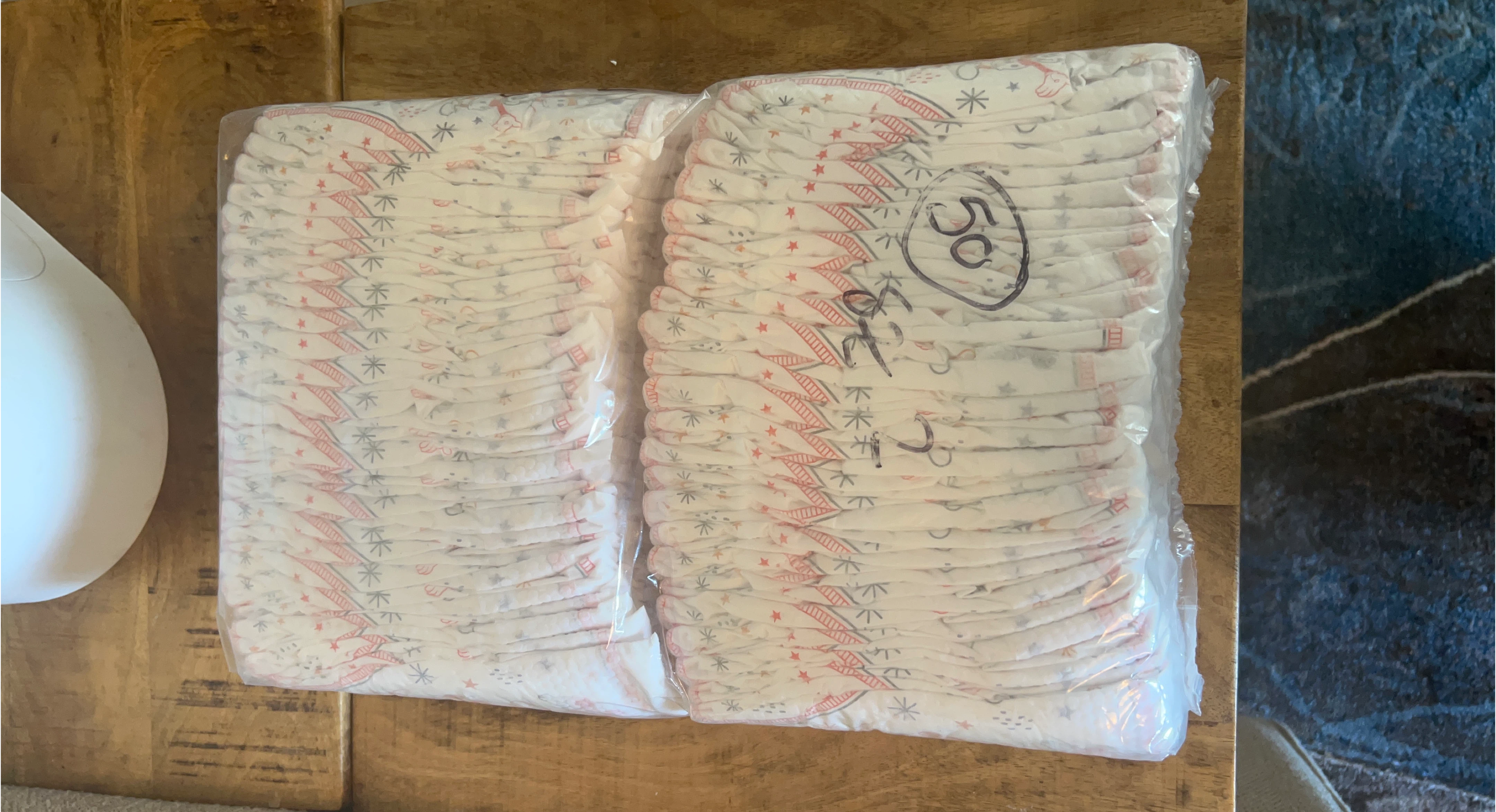 Two packs of diapers, size 2 & 3