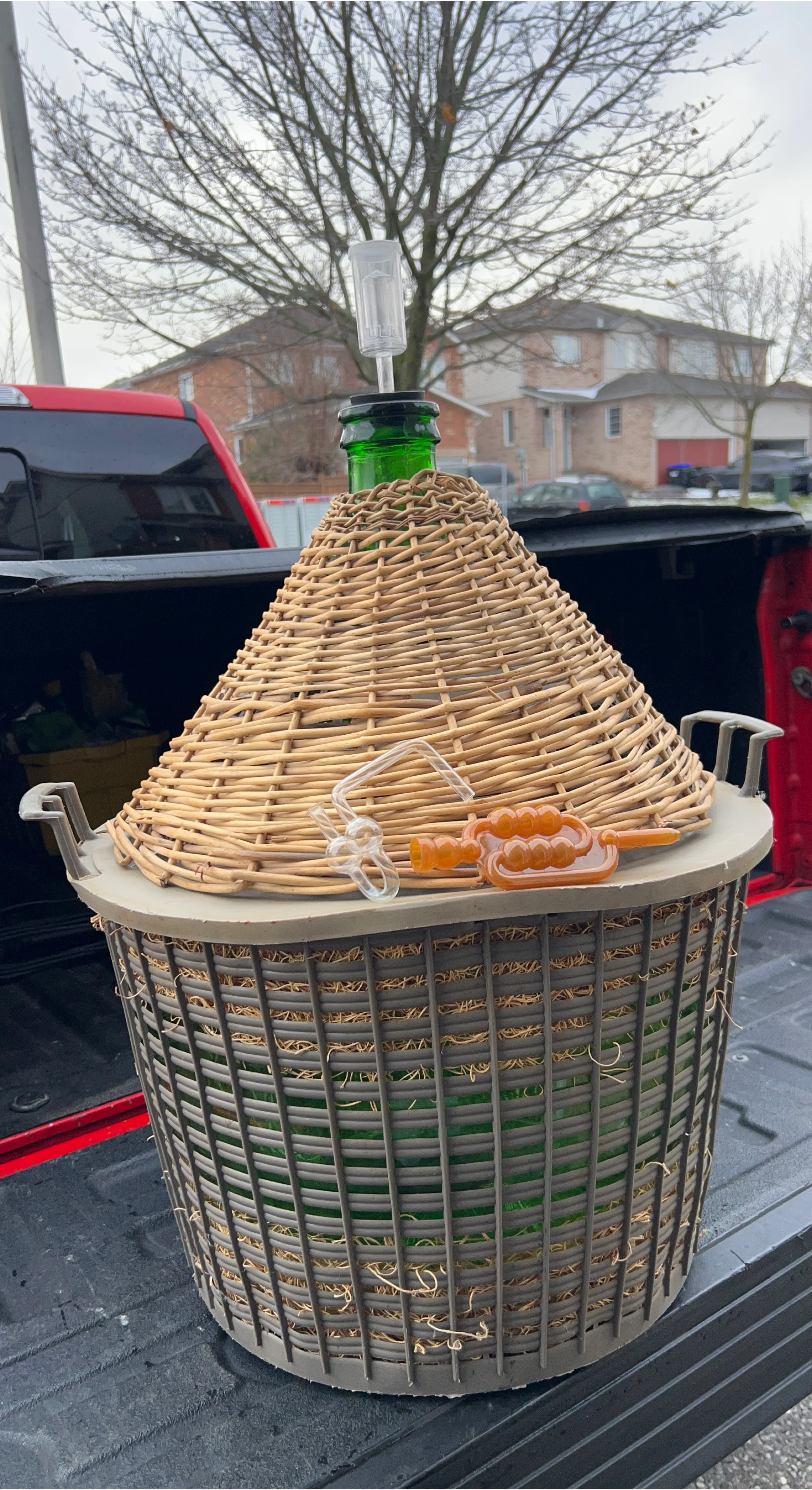 Vintage Green Glass Demijohn Carboy in Wicker Basket