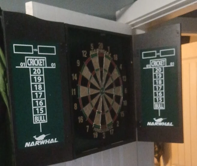 Narwhal Dartboard in a dark wood Cabinet