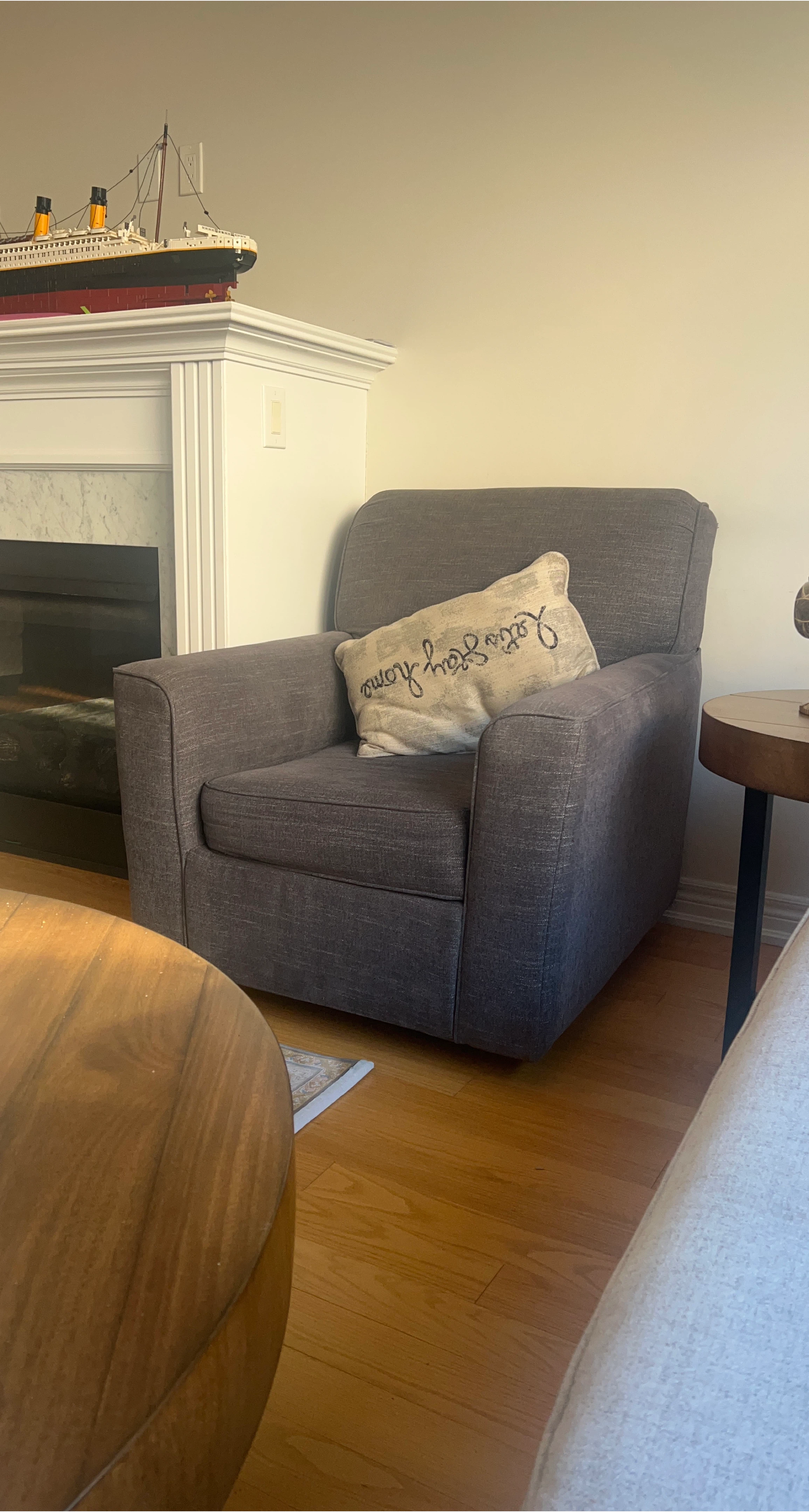 Grey accent chair with throw pillow