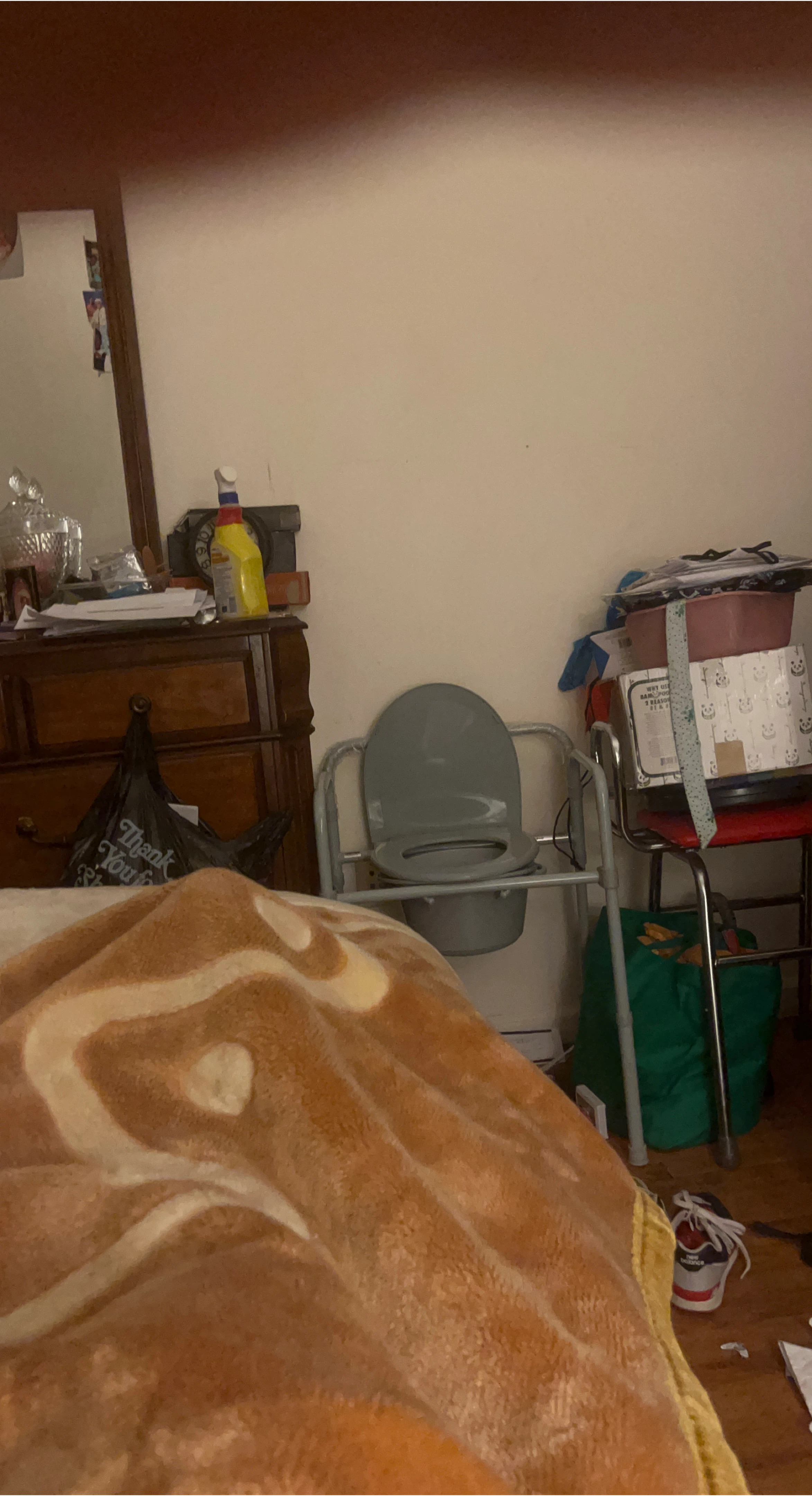 Gray medical commode chair with adjustable legs