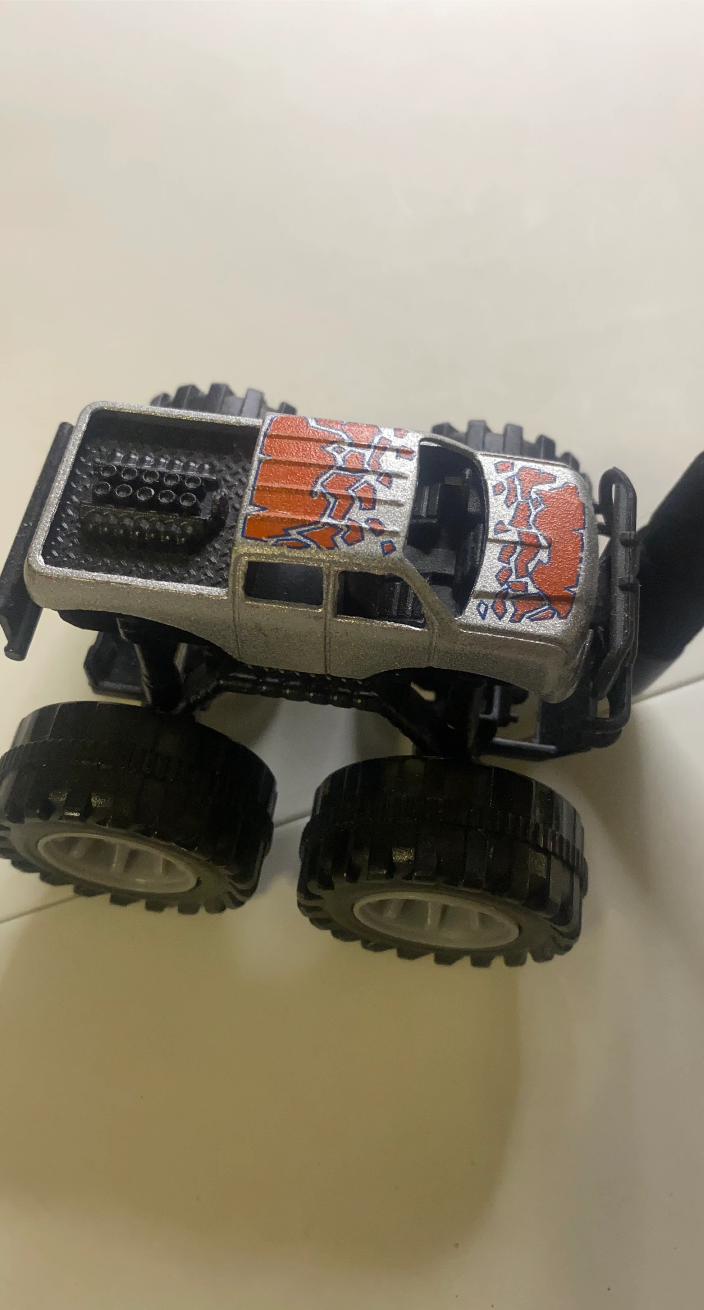 Toy Monster Truck with Orange and Blue Decals