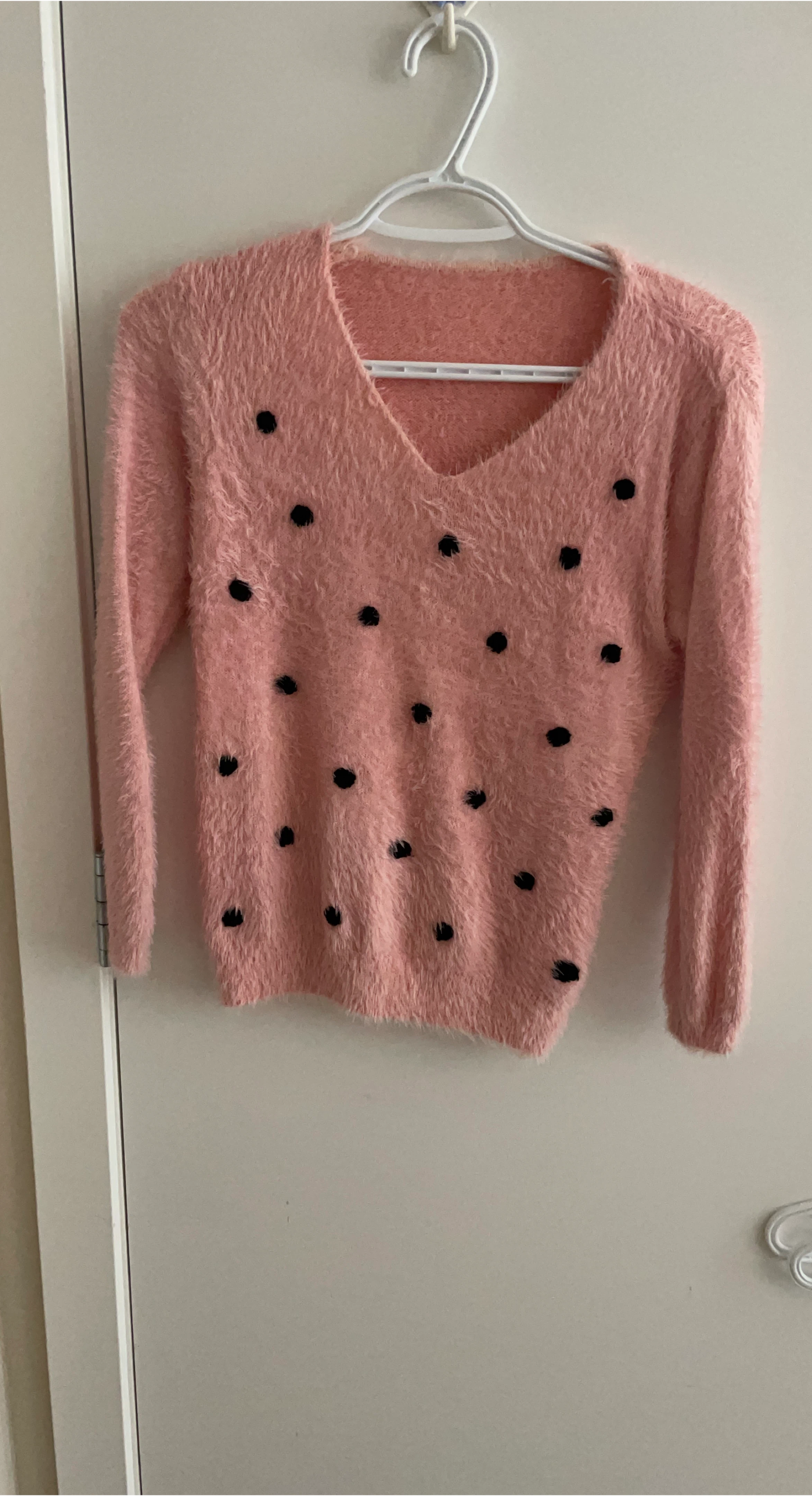 Pink fuzzy sweater with black polka dots