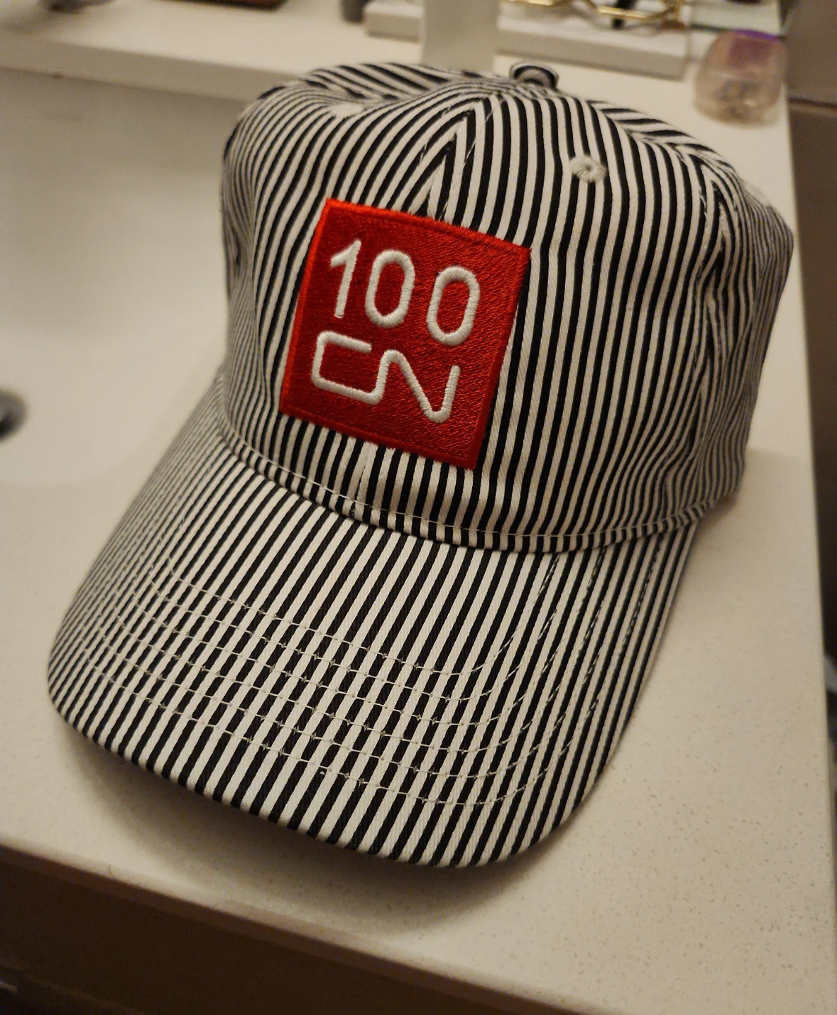 Striped Baseball Cap with Red 100 CN Patch