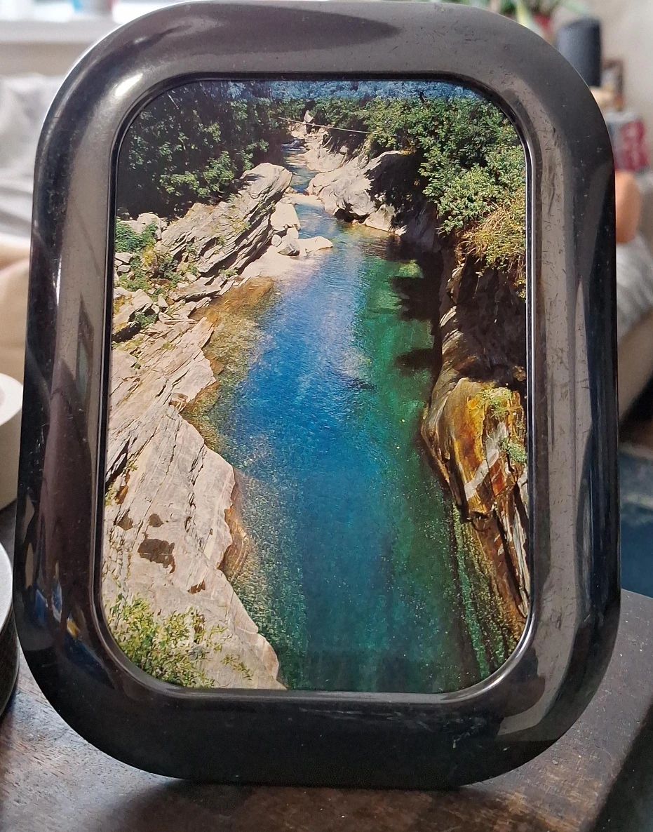 Black Oval Picture Frame with Landscape Photo