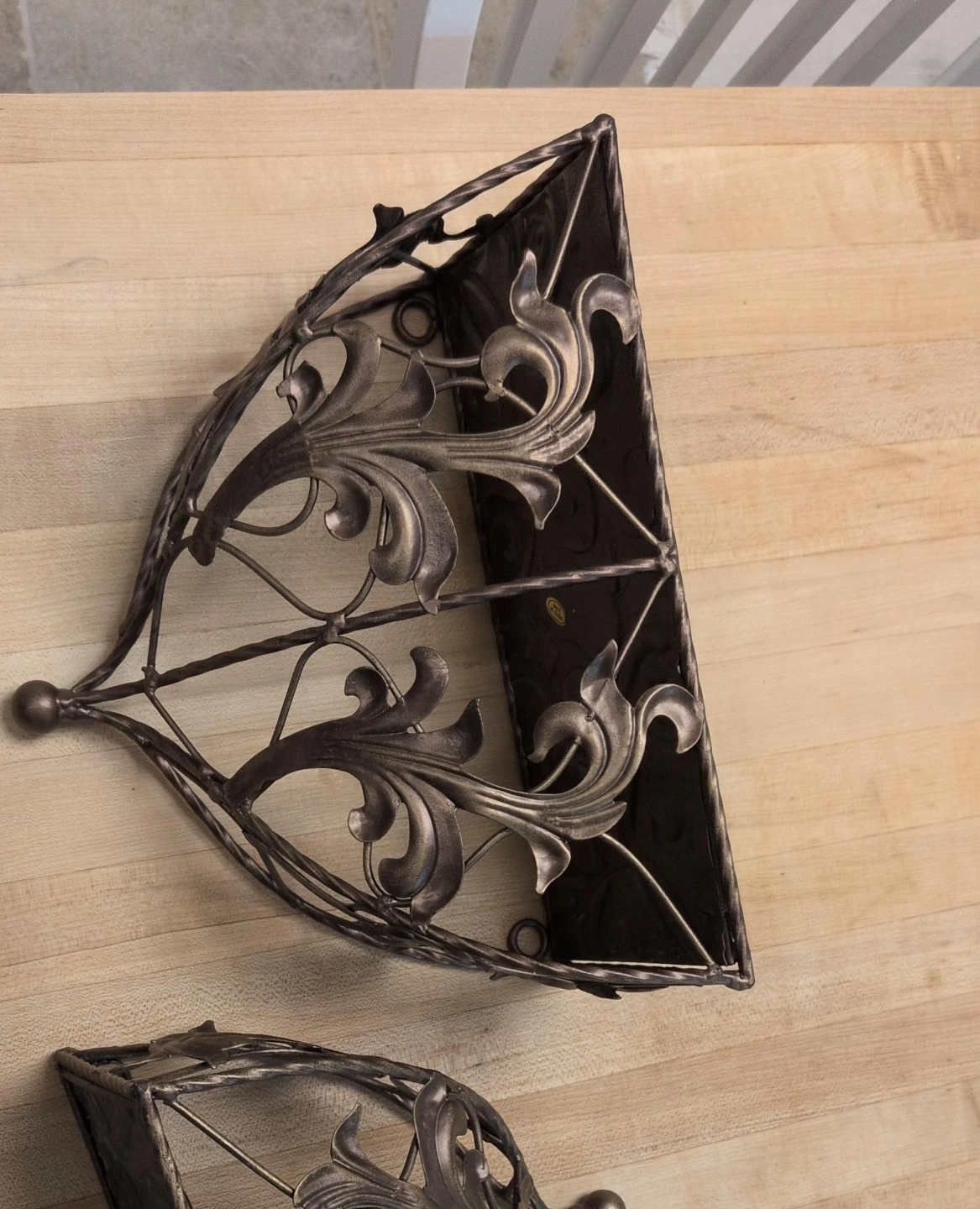 Two metal ornate shelves