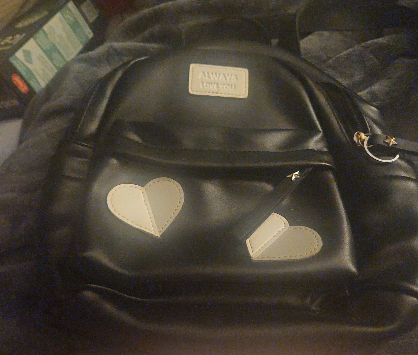 Black faux leather backpack with heart details