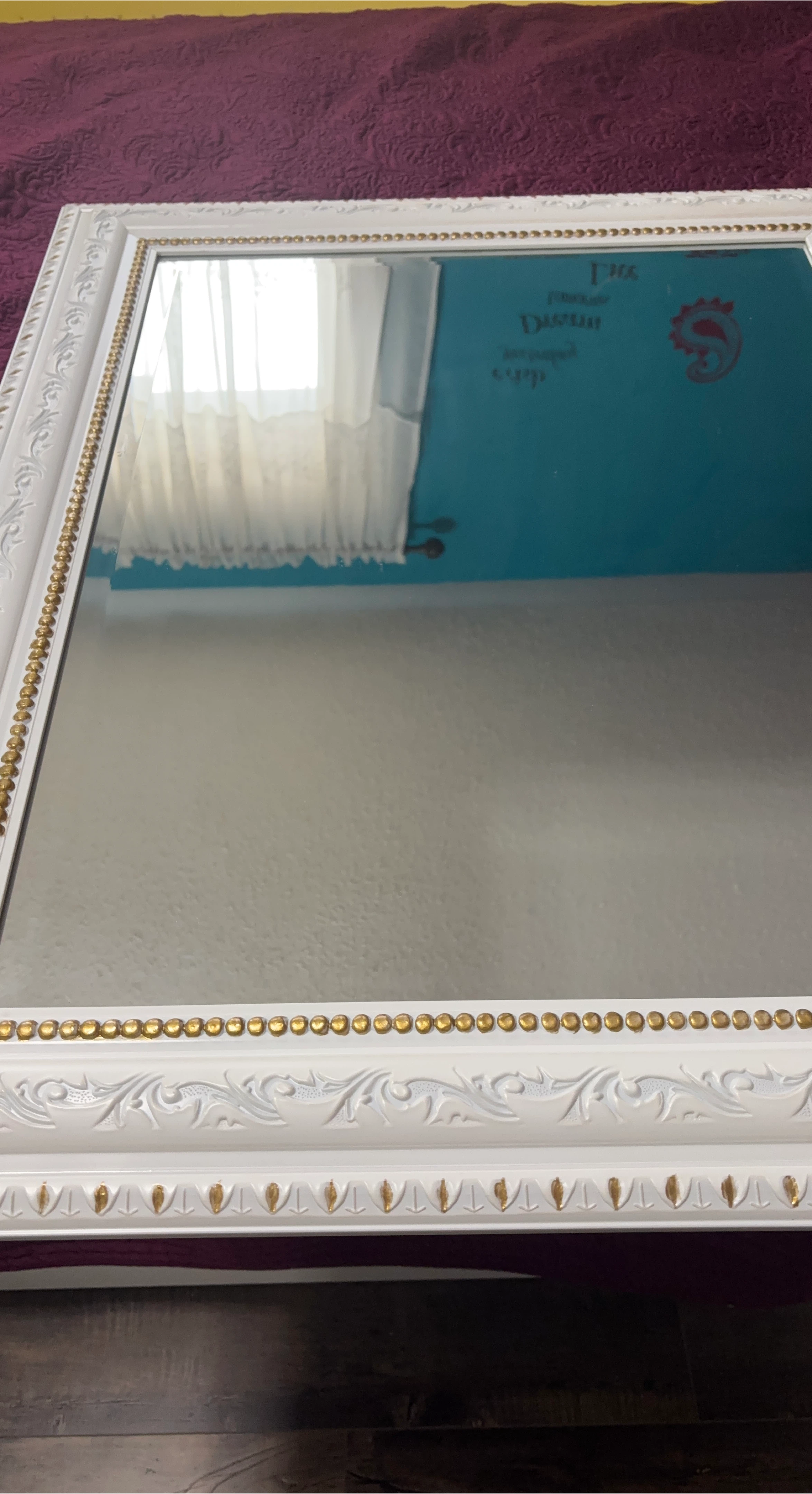 White ornate mirror with gold bead trim