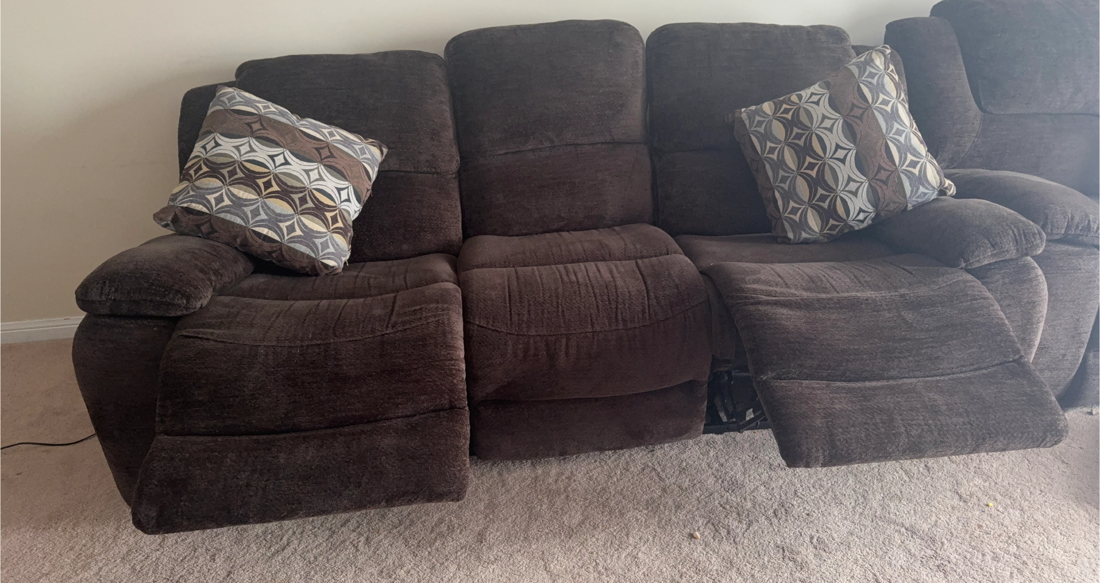Brown Reclining Sofa with Decorative Pillows