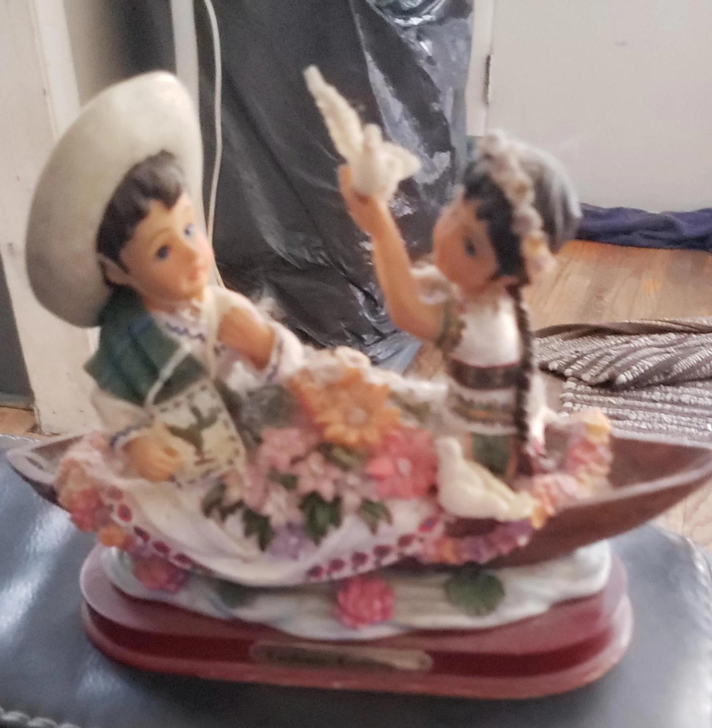 Figurine of children in a boat with doves