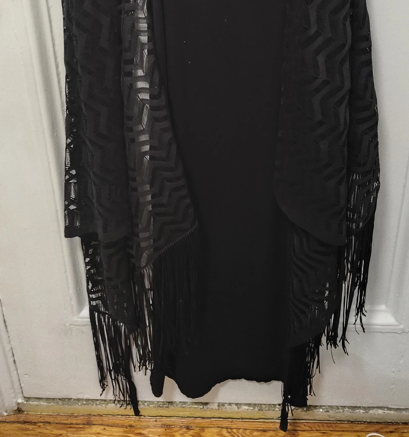 Black sleeveless open front vest with fringe